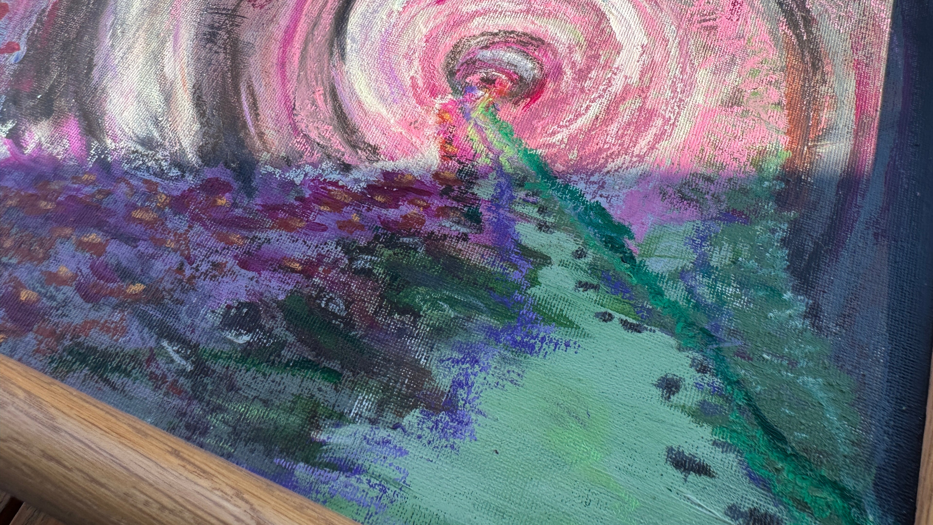 Pink, purple, and green artwork outdoors with the sun beaming on the top.