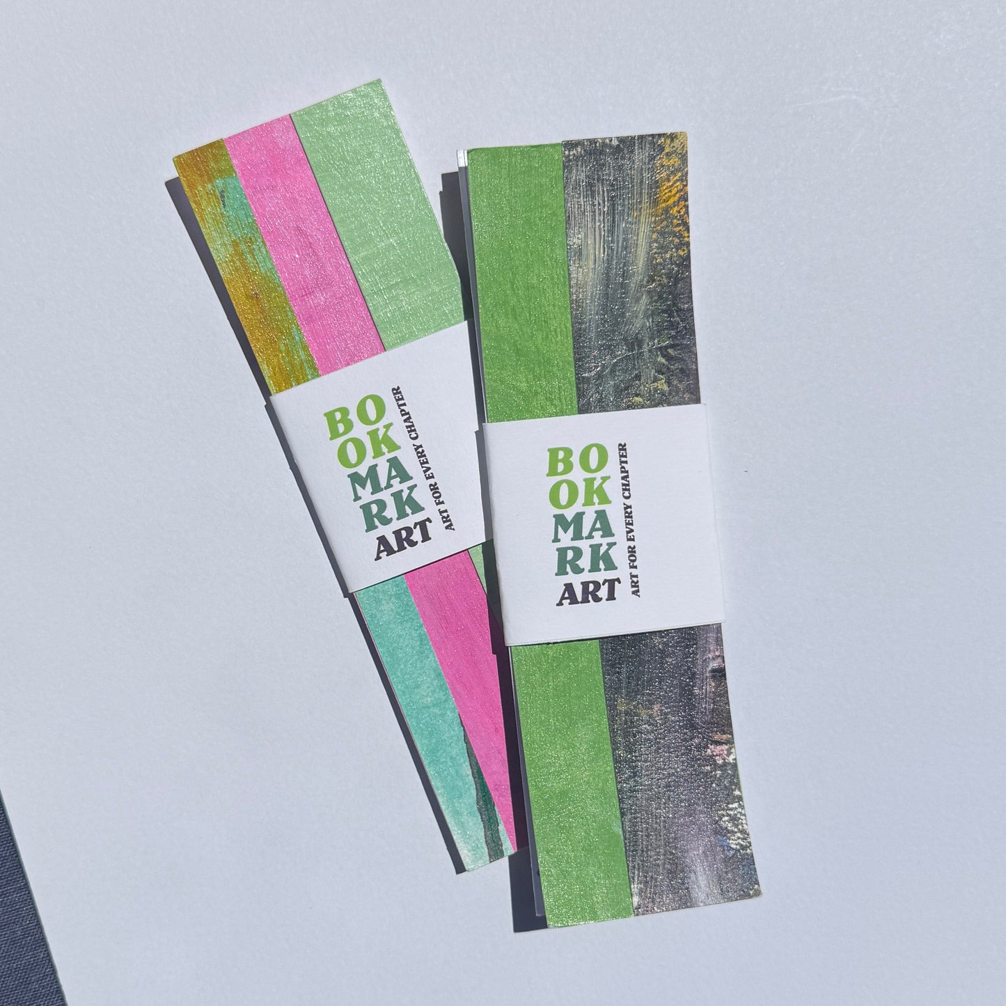 Two striped bookmarks with a white label on a light gray background