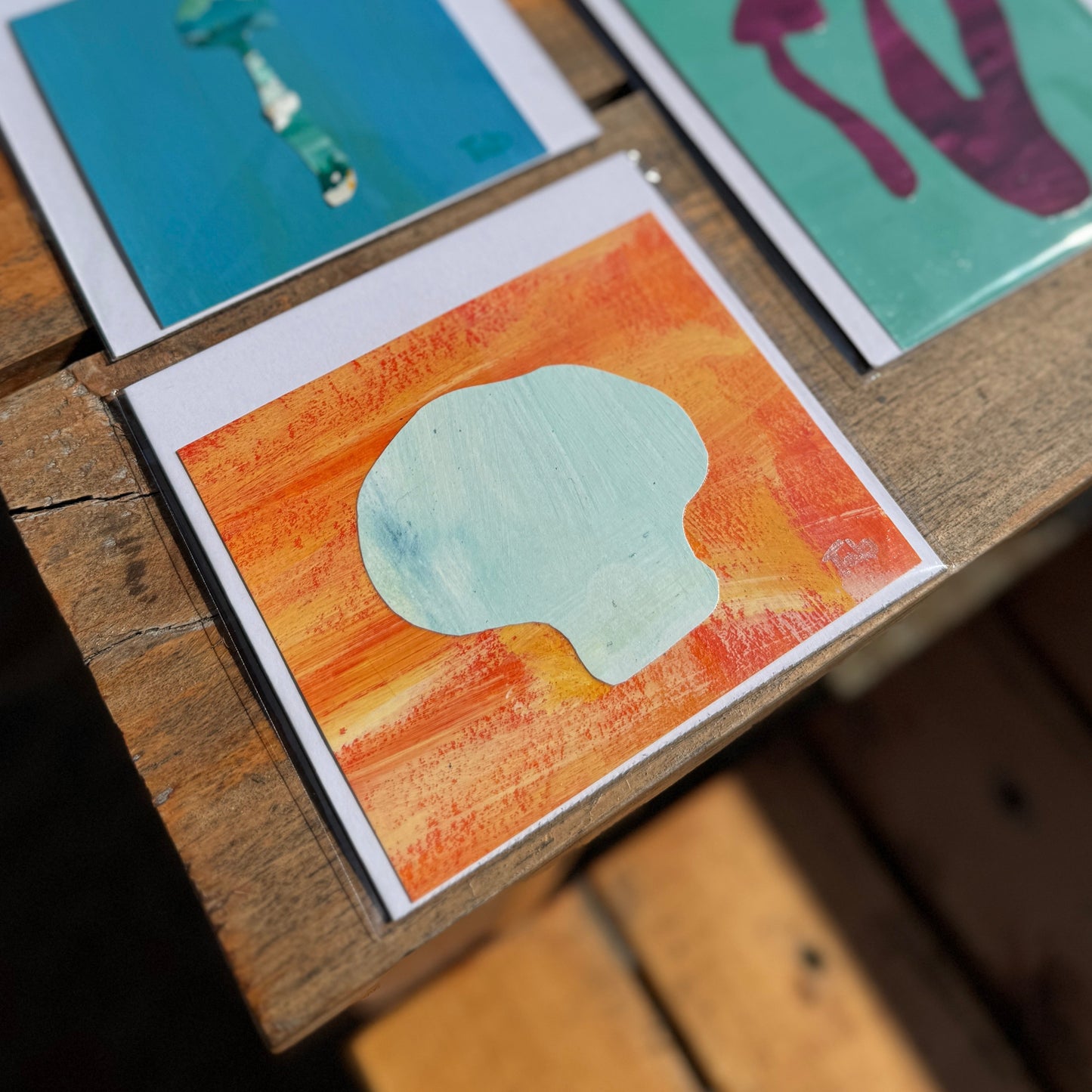 Small light blue abstract mushroom with orange background.