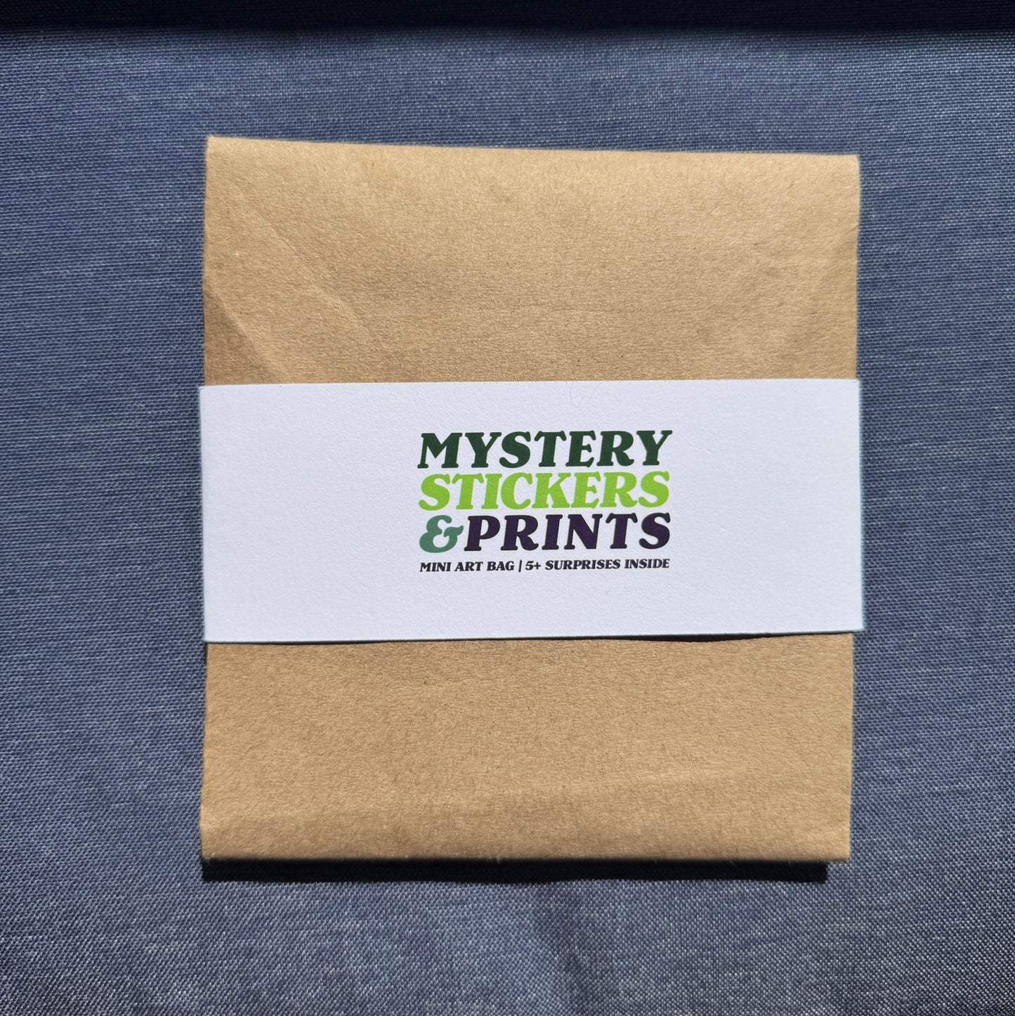 Kraft paper box with a white label on a blue textured surface