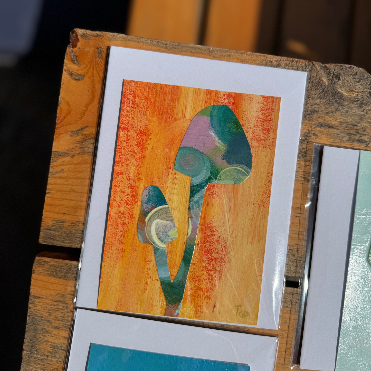 Colorful abstract mushroom collage on a wooden table.