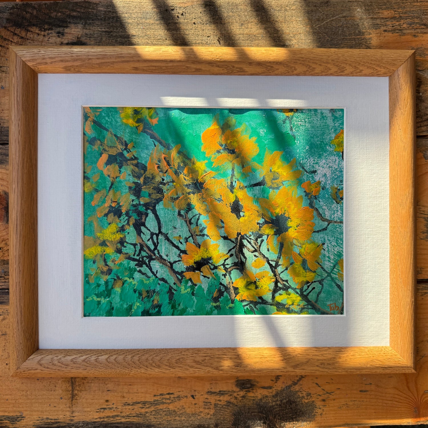 Original artwork of yellow and black abstract flowers with a green background. 