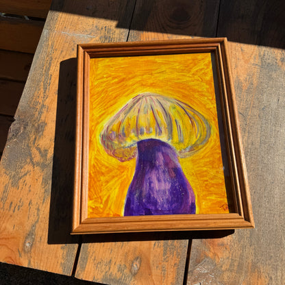 Vibrant yellow and purple mushroom artwork in the sunlight, lying on a sunlit wooden bench.