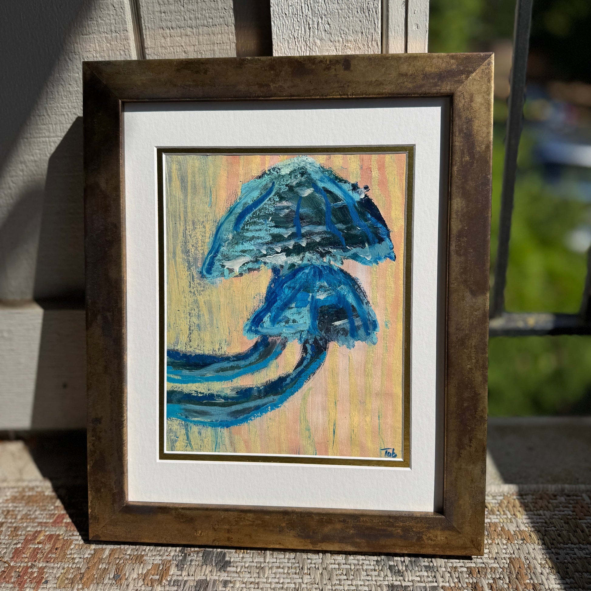 Framed abstract mushroom artwork with blue and beige colors on a textured surface.
