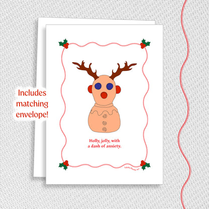 Cute holiday greeting card with a matching white envelope on a textured gray background. A graphic red wiggle line is on the right side of the image, matching the texture on the card.
