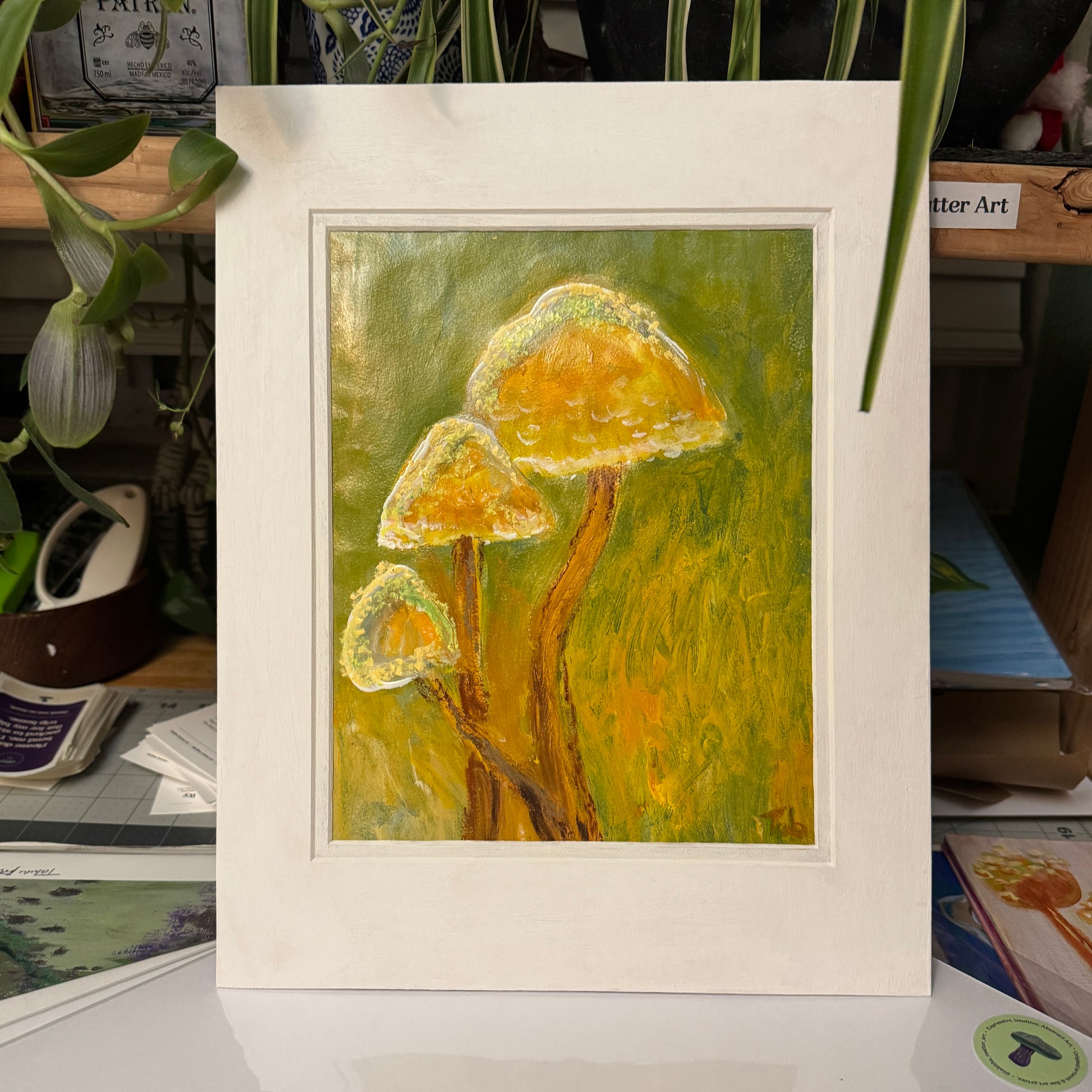Nature-inspired, multimedia artwork, Golden Hour, on a sunny day in the artist's studio.. Full view of the artwork in the white matte. 
