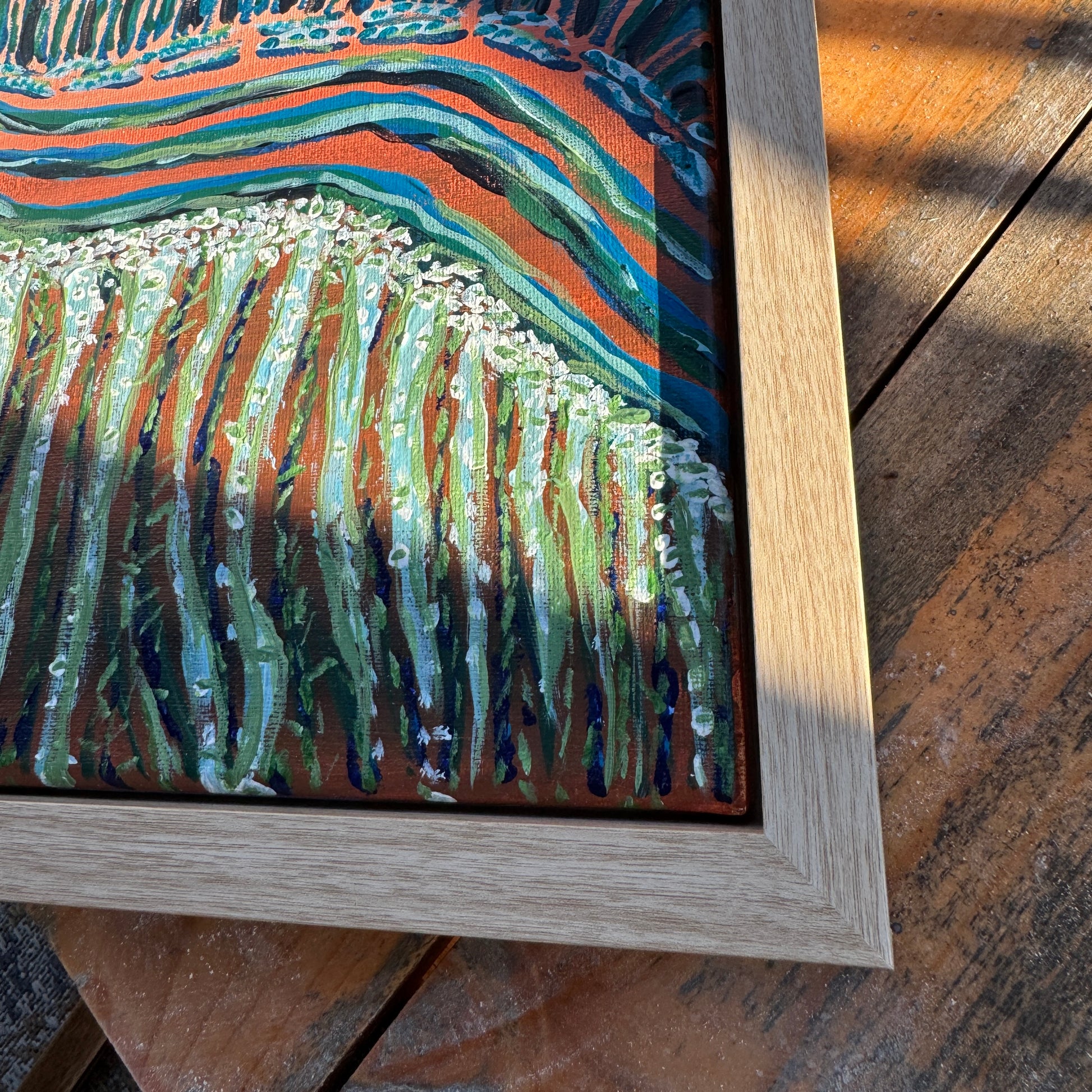 A close-up of Move Along Everyone, framed. Showing the bottom right corner of the floater frame.