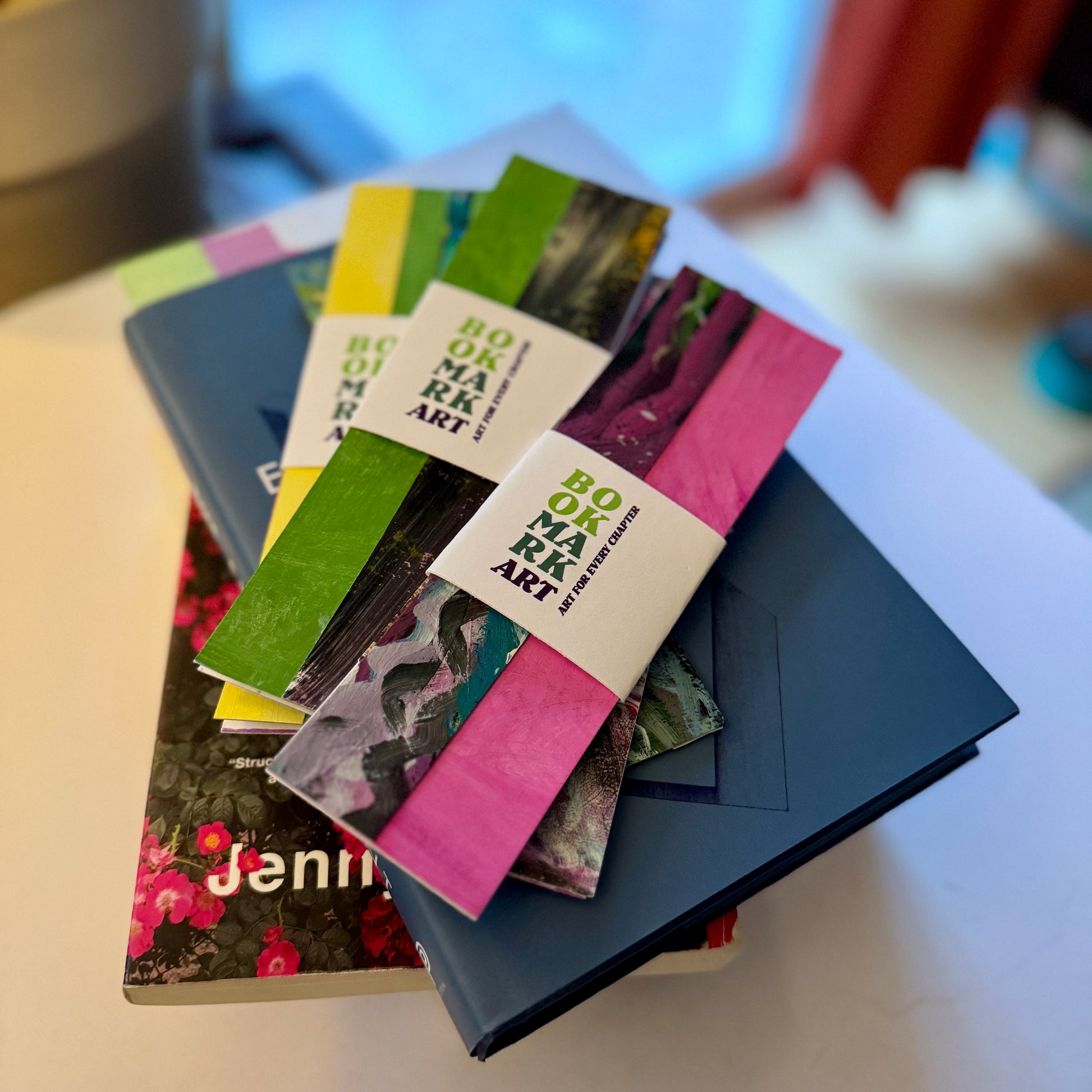 Stack of colorful bookmarks with 'Bookmark Art' labels on a white surface.