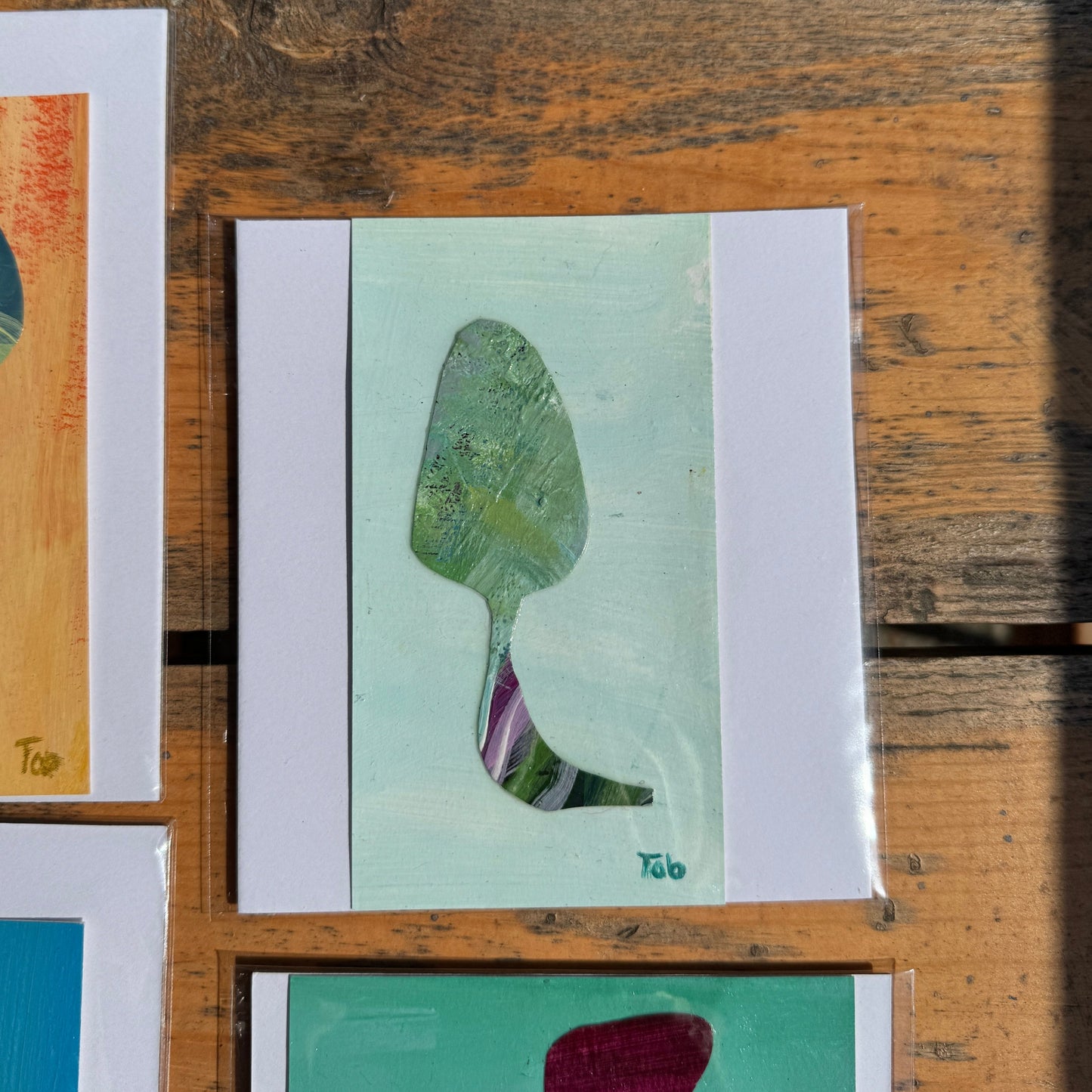A collage of abstract art pieces on a wooden frame.
